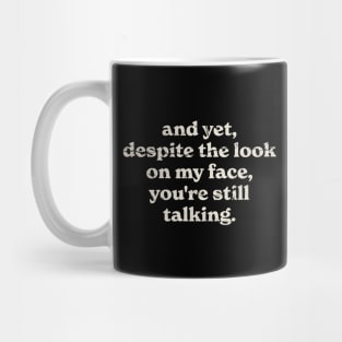 Funnytee, And Yet despite the look on my face, you're still talking, Original Black Mug